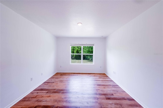 2950 Gibraltar Blvd, New Smyrna Beach, FL 32168 - empty room with baseboards and wood finished floors