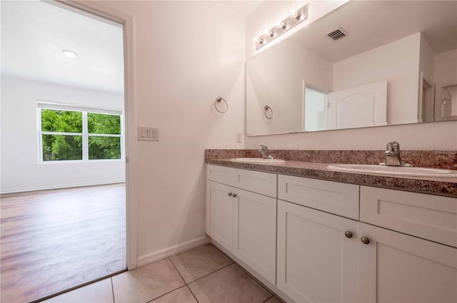 2950 Gibraltar Blvd, New Smyrna Beach, FL 32168 - bathroom with double vanity, visible vents, tile patterned floors, and a sink