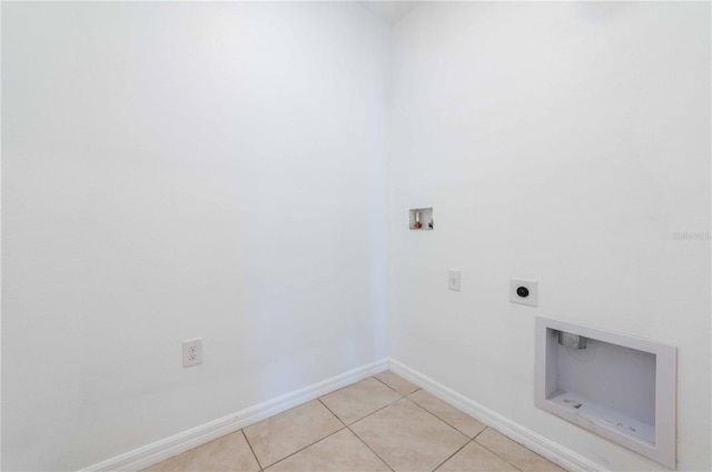 2950 Gibraltar Blvd, New Smyrna Beach, FL 32168 - laundry room with hookup for a washing machine, hookup for an electric dryer, light tile patterned floors, baseboards, and laundry area