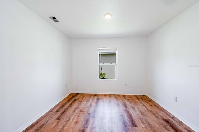 2950 Gibraltar Blvd, New Smyrna Beach, FL 32168 - empty room featuring baseboards, wood finished floors, and visible vents