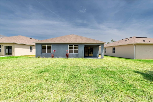 2950 Gibraltar Blvd, New Smyrna Beach, FL 32168 - rear view of house with a lawn, a shingled roof, and stucco siding