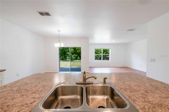 2950 Gibraltar Blvd, New Smyrna Beach, FL 32168 - kitchen featuring a sink, open floor plan, light countertops, decorative light fixtures, and visible vents