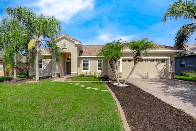 view of front of home featuring a garage and a front lawn