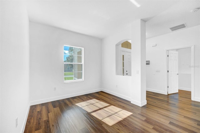 spare room featuring dark wood-type flooring