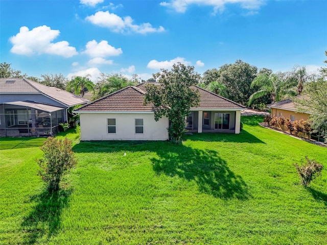 rear view of property featuring a yard