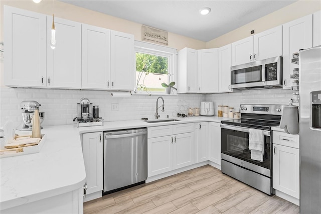 kitchen featuring white cabinetry, appliances with stainless steel finishes, and sink