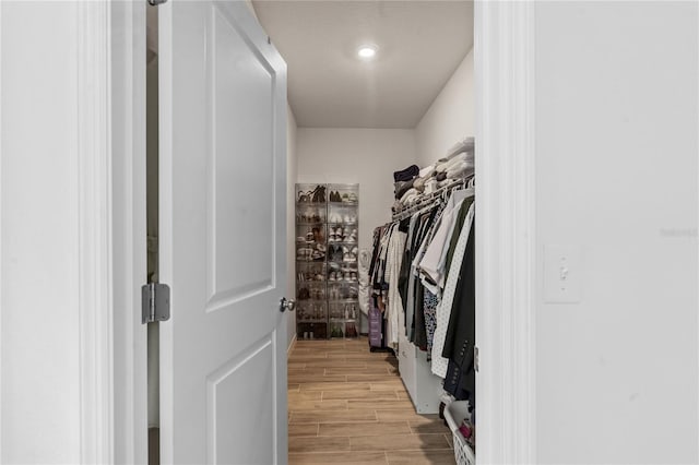 spacious closet with light hardwood / wood-style flooring