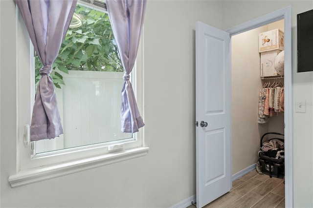 interior space featuring a walk in closet, a closet, and light hardwood / wood-style floors