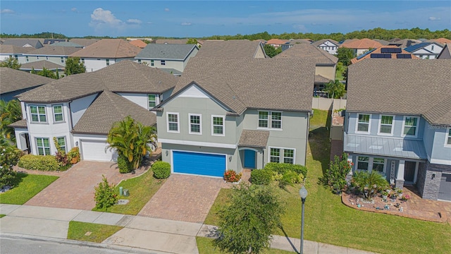 view of front of home with a garage and a front lawn