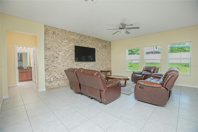 tiled living room featuring ceiling fan and a wealth of natural light