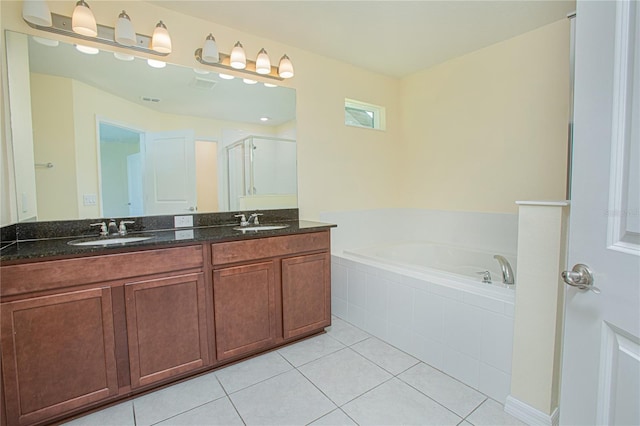 bathroom with tile patterned flooring, vanity, and independent shower and bath