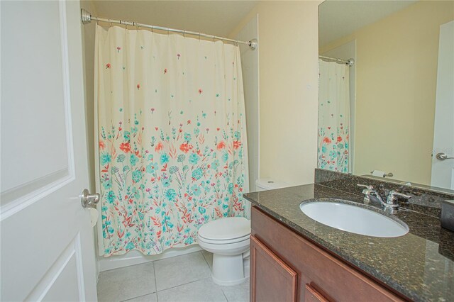 bathroom with vanity, tile patterned floors, and toilet