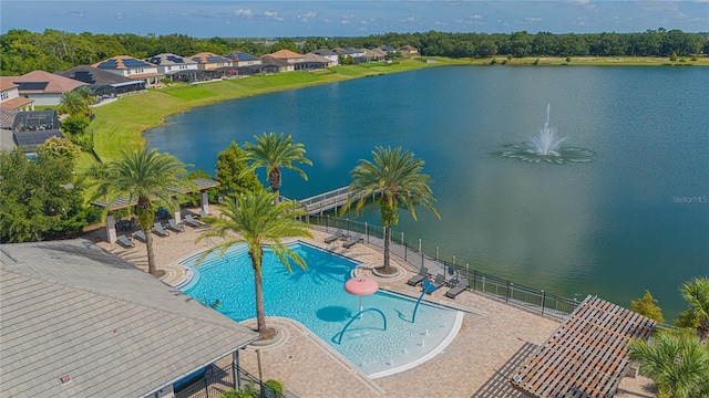 view of swimming pool with a water view and a patio area