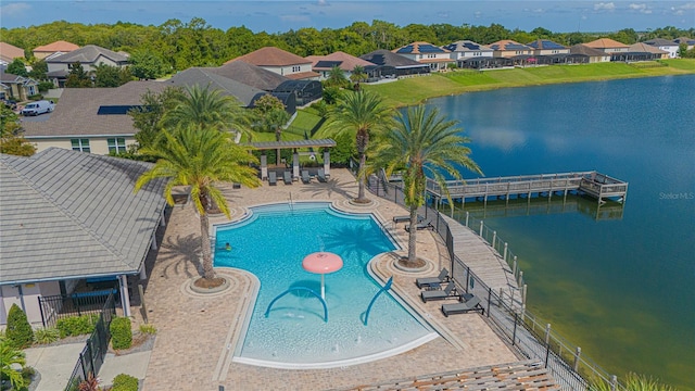 view of pool featuring a water view and a patio area