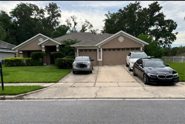 ranch-style house with a garage and a front yard