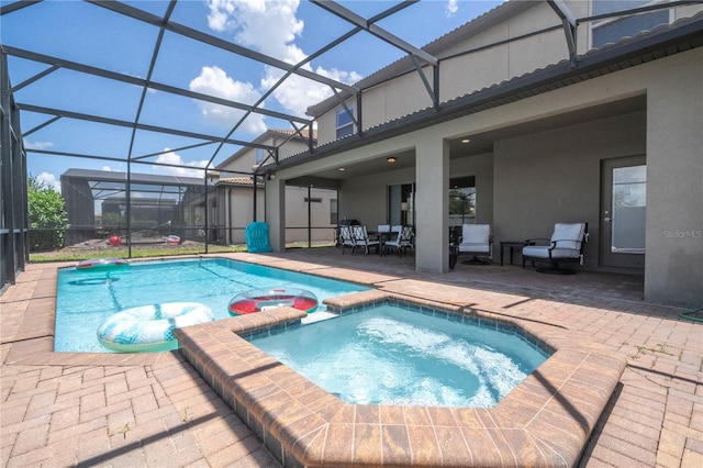 view of swimming pool featuring a patio, an in ground hot tub, and glass enclosure