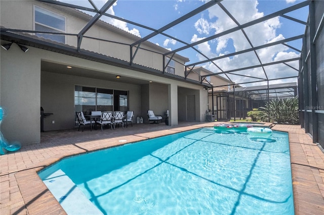 view of swimming pool with a patio and a lanai