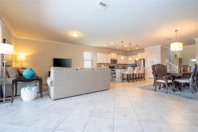 living room featuring a notable chandelier, light tile patterned floors, and ornamental molding