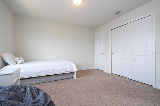 carpeted bedroom with a closet