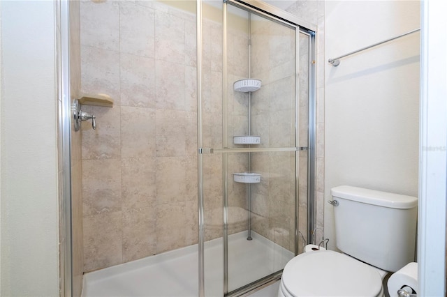 bathroom with walk in shower and toilet