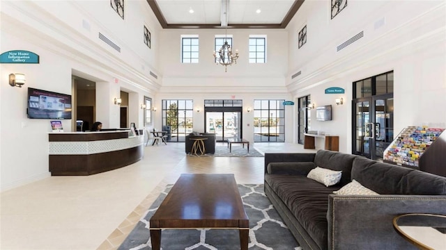 tiled living room featuring beam ceiling, a towering ceiling, a chandelier, and ornamental molding