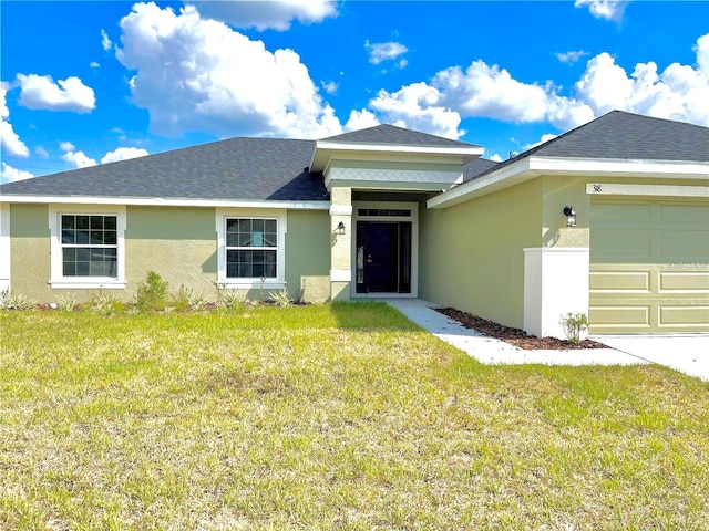 view of front facade featuring a garage and a front lawn