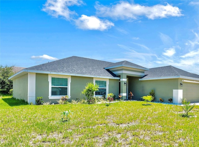 view of front of home featuring a garage and a front yard