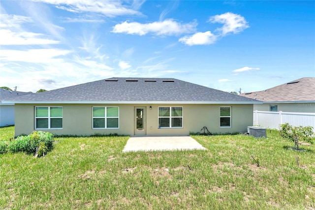 back of house featuring a patio area, central AC unit, and a lawn