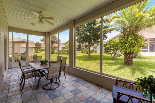 sunroom featuring ceiling fan