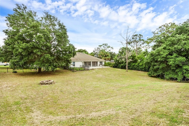 view of yard with a fire pit