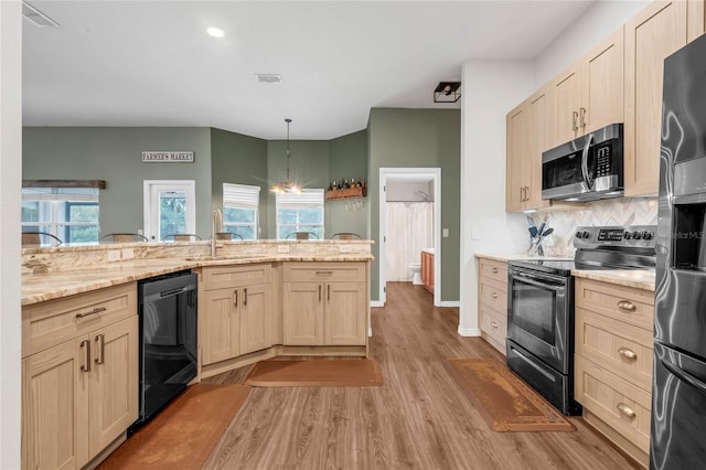 kitchen featuring appliances with stainless steel finishes, sink, light hardwood / wood-style flooring, pendant lighting, and light brown cabinets