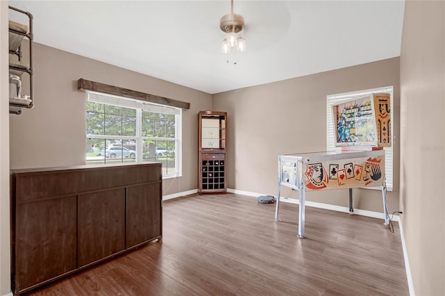 unfurnished office with light wood-type flooring and ceiling fan