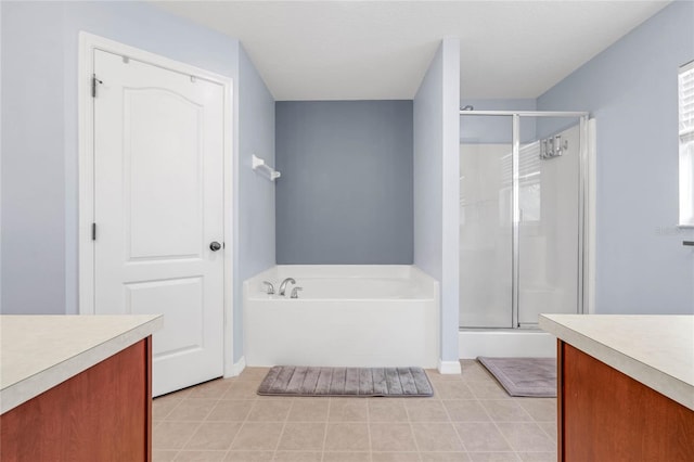 bathroom featuring vanity, tile patterned floors, and plus walk in shower