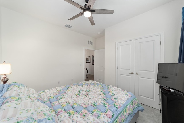 bedroom with a closet, light colored carpet, and ceiling fan