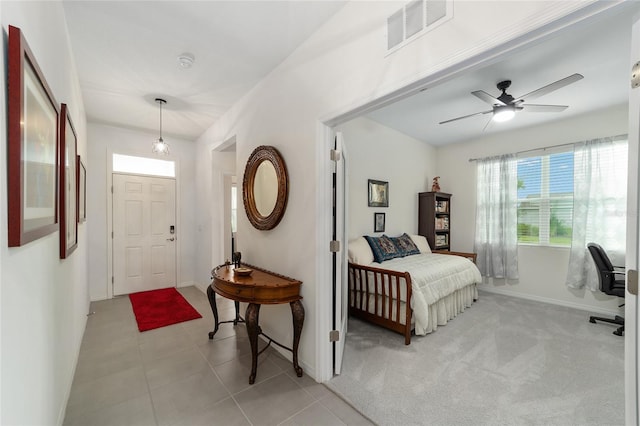 interior space with light tile patterned floors and ceiling fan