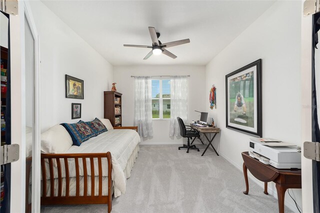 bedroom with light colored carpet and ceiling fan