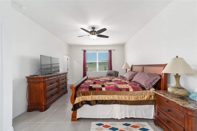 tiled bedroom featuring ceiling fan