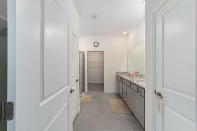 bathroom featuring tile patterned flooring and double sink vanity