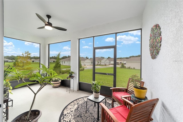 sunroom featuring ceiling fan