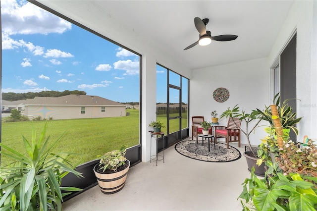 sunroom featuring ceiling fan