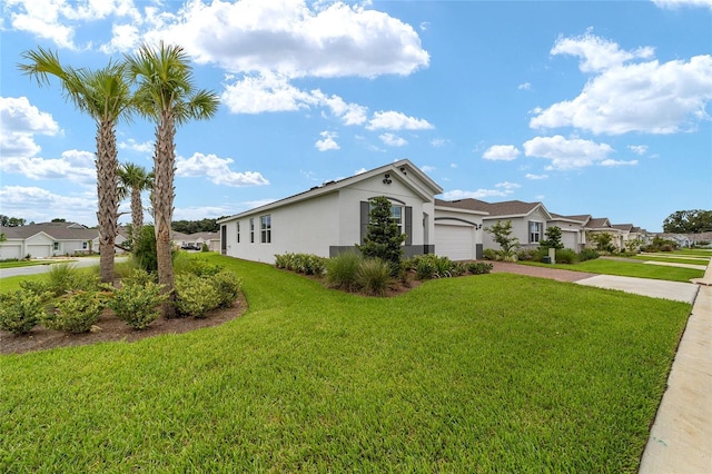 view of side of home with a garage and a yard