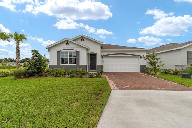 ranch-style house with a garage, cooling unit, and a front yard