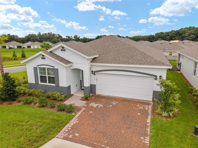 single story home featuring a garage and a front yard