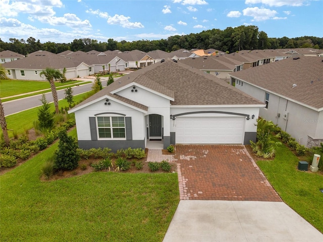 ranch-style home with a garage and a front lawn