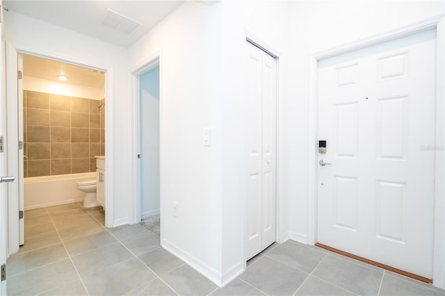 entryway with light tile patterned floors