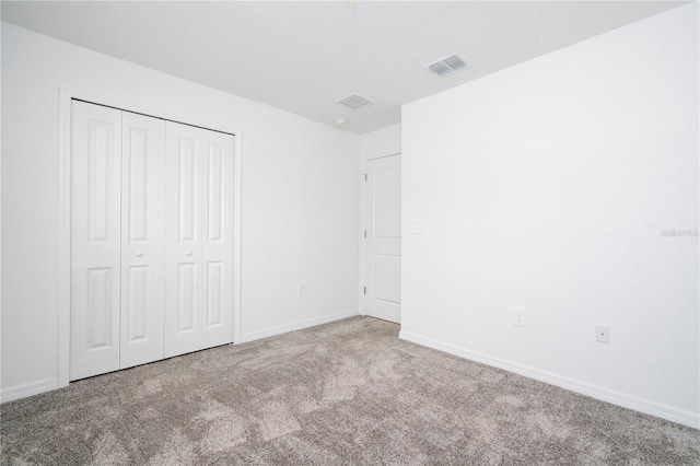 unfurnished bedroom featuring a closet and carpet