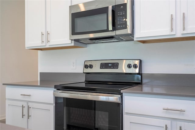 kitchen featuring white cabinetry and appliances with stainless steel finishes