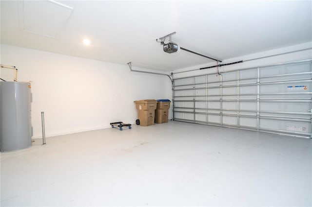 garage with a garage door opener and electric water heater