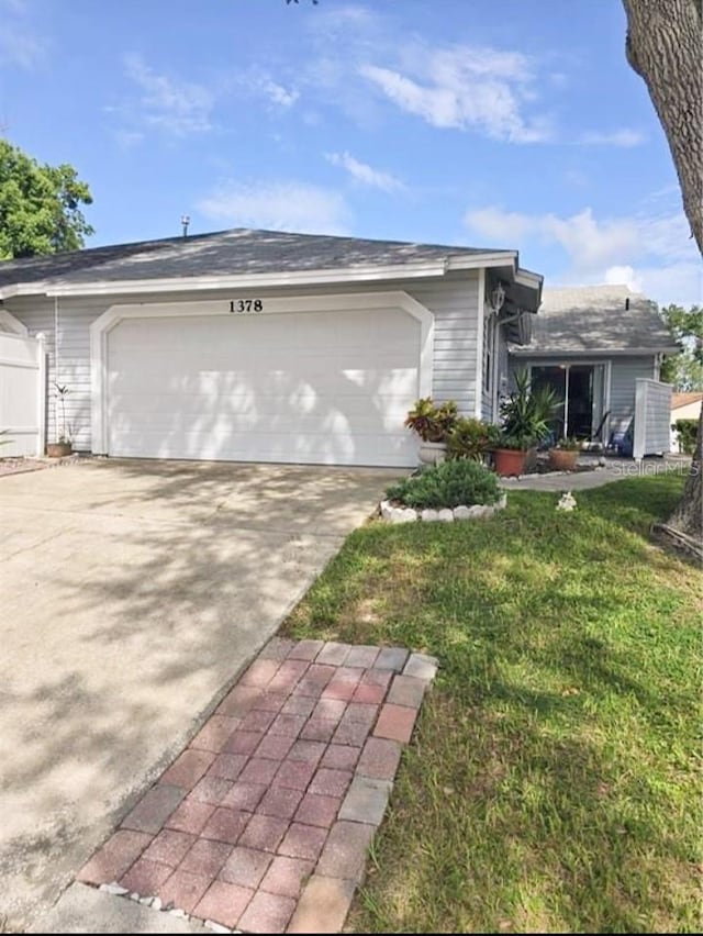 view of side of home featuring a garage and a yard