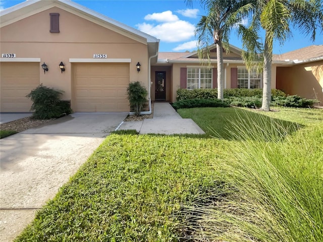 ranch-style home with a garage and a front yard